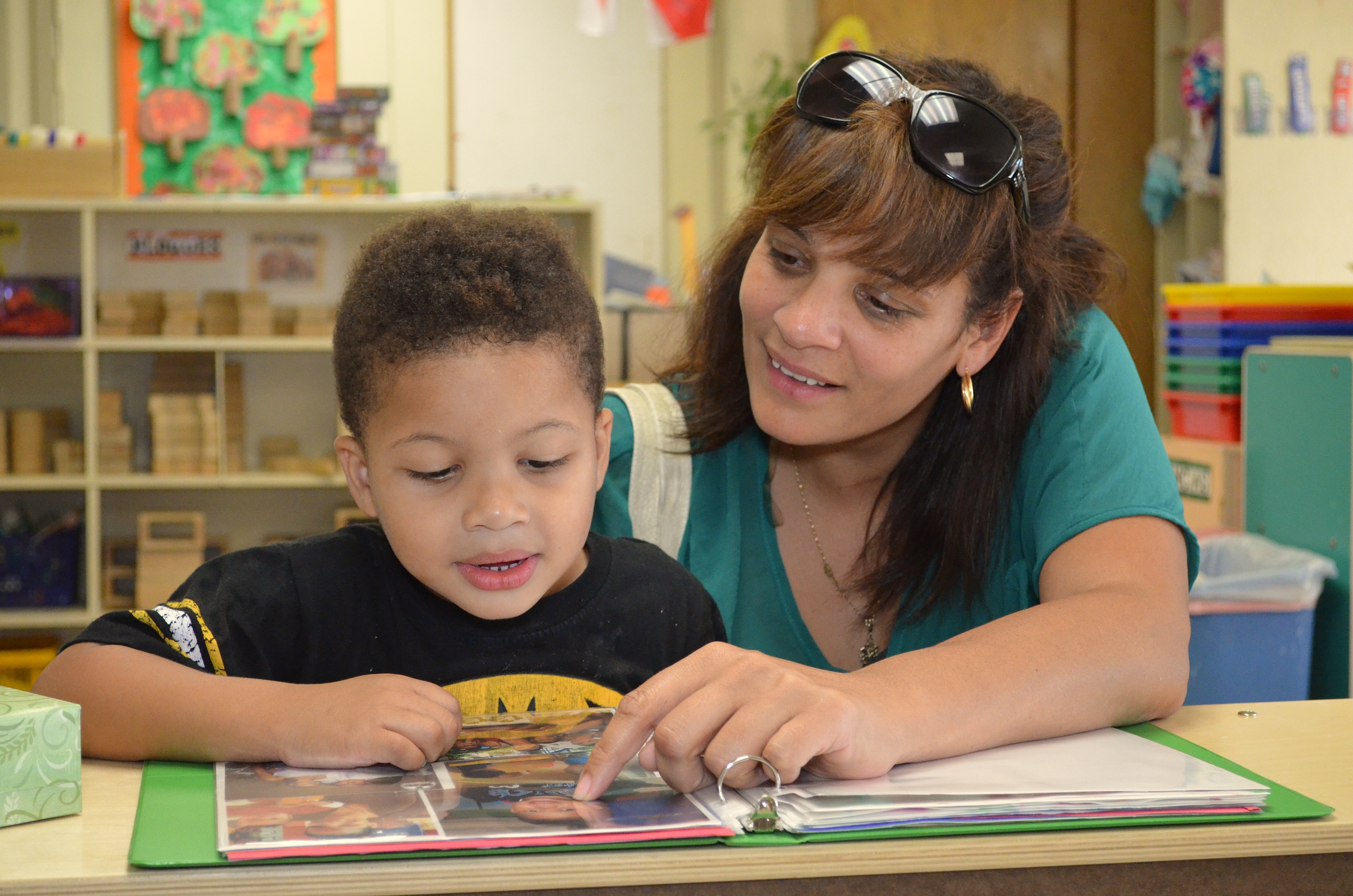 Mom reading with son at child care